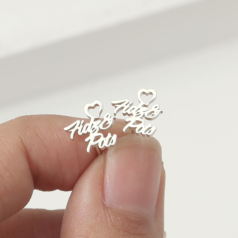 A pair of silver heart-shaped earrings with customisable name design.