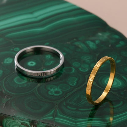 Silver and gold rings on green textured background