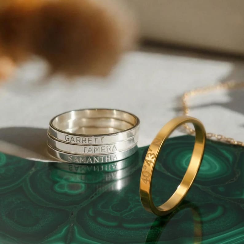 Silver and gold rings on green and white background