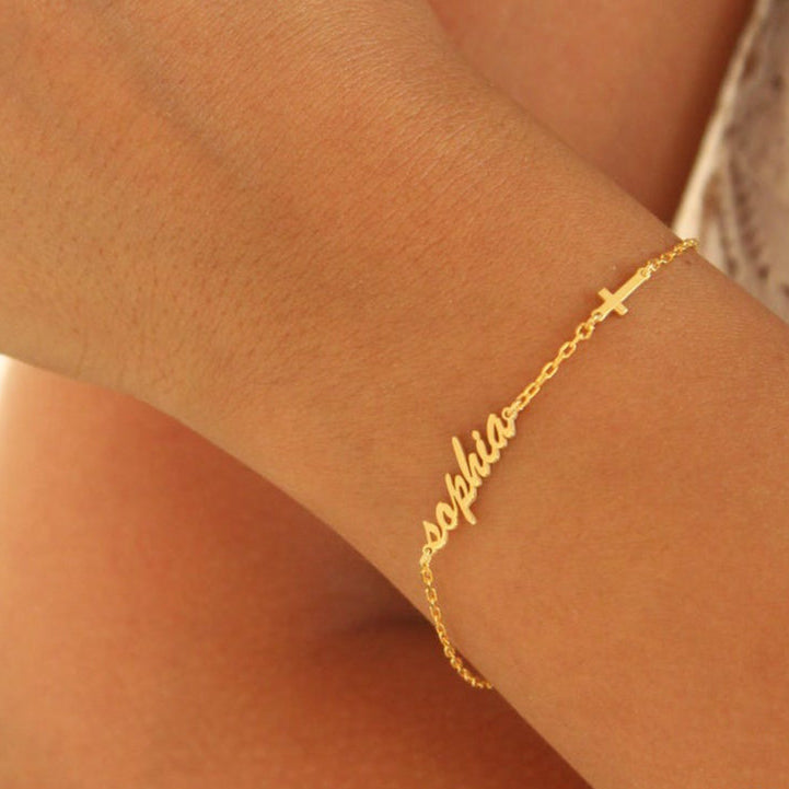 Gold bracelet with 'sophia' on a wrist