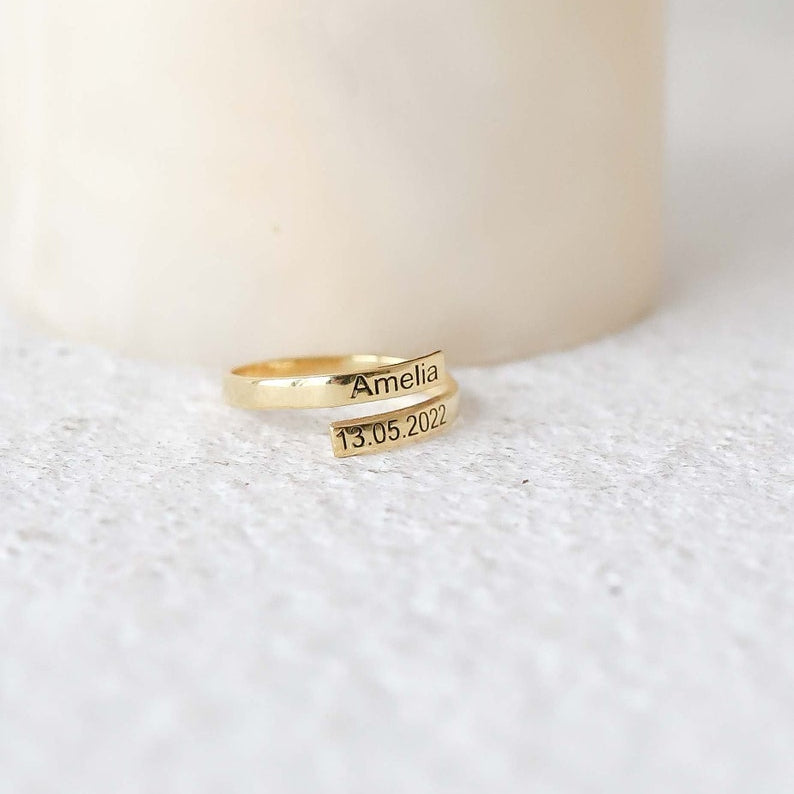 Gold ring with engraving on a white surface