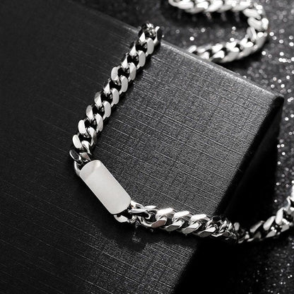 A silver-coloured, titanium steel necklace with a six-sided grinding NK chain design, displayed on a black box.