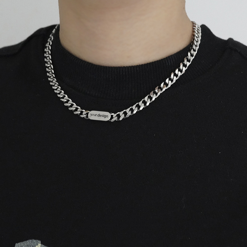 A silver-coloured, titanium steel necklace with a six-sided grinding NK chain design.