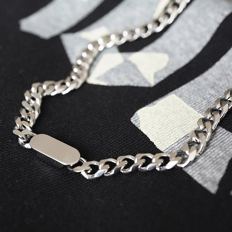A silver-coloured, titanium steel necklace with a six-sided grinding NK chain design.