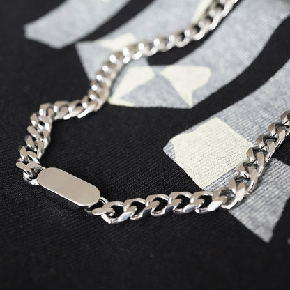 A silver-coloured, titanium steel necklace with a six-sided grinding NK chain design.