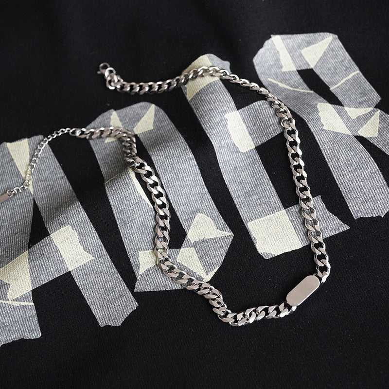 A silver-coloured, titanium steel necklace with a six-sided grinding NK chain design.