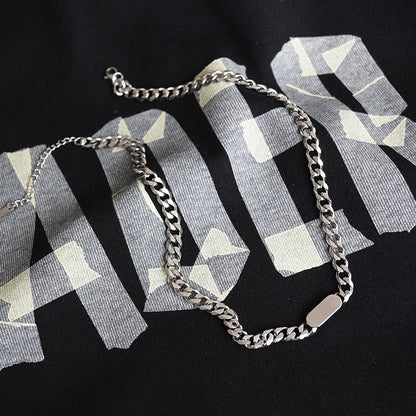 A silver-coloured, titanium steel necklace with a six-sided grinding NK chain design.